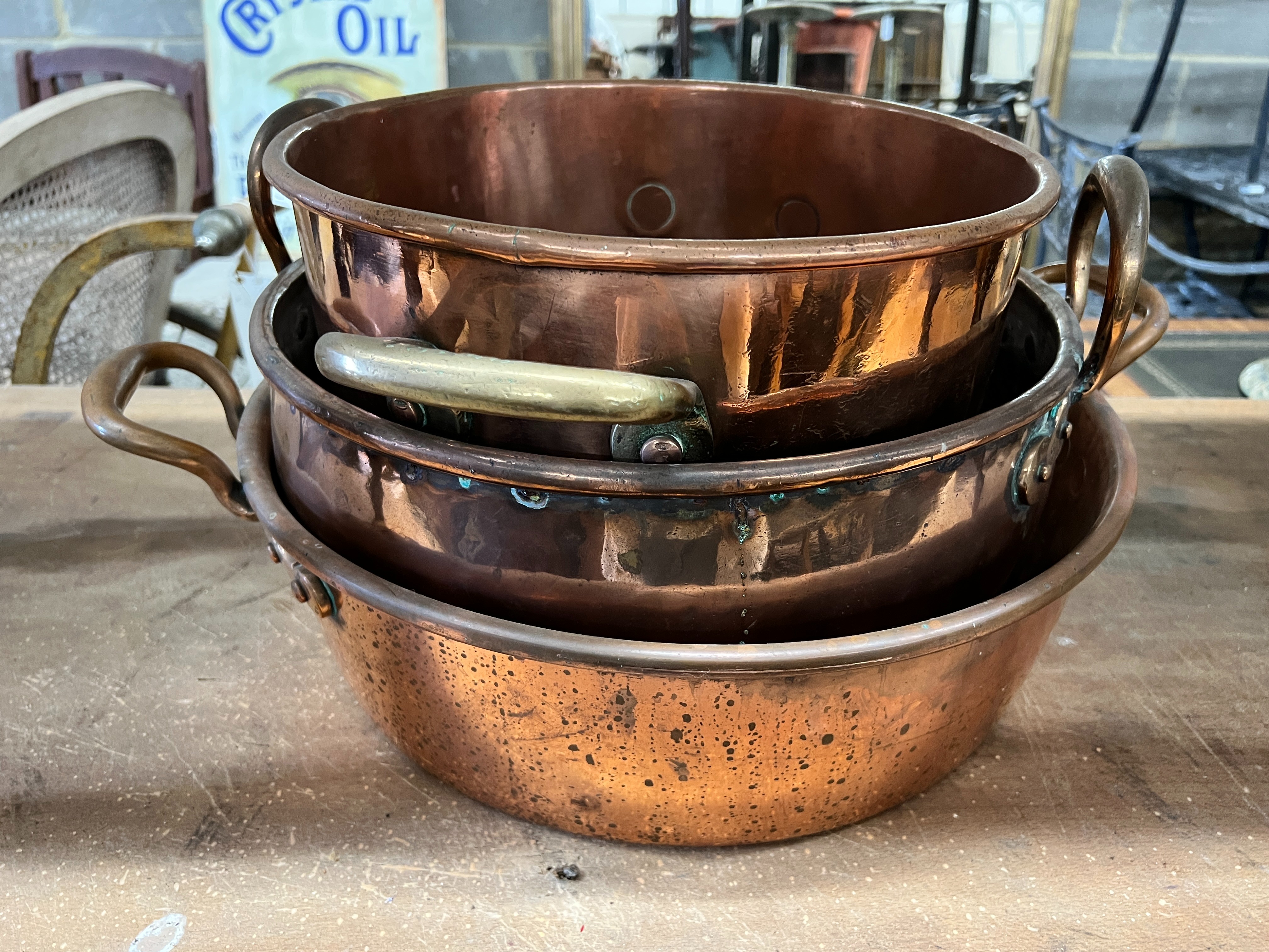 Three Victorian circular copper two handled preserve pans, largest diameter 43cm